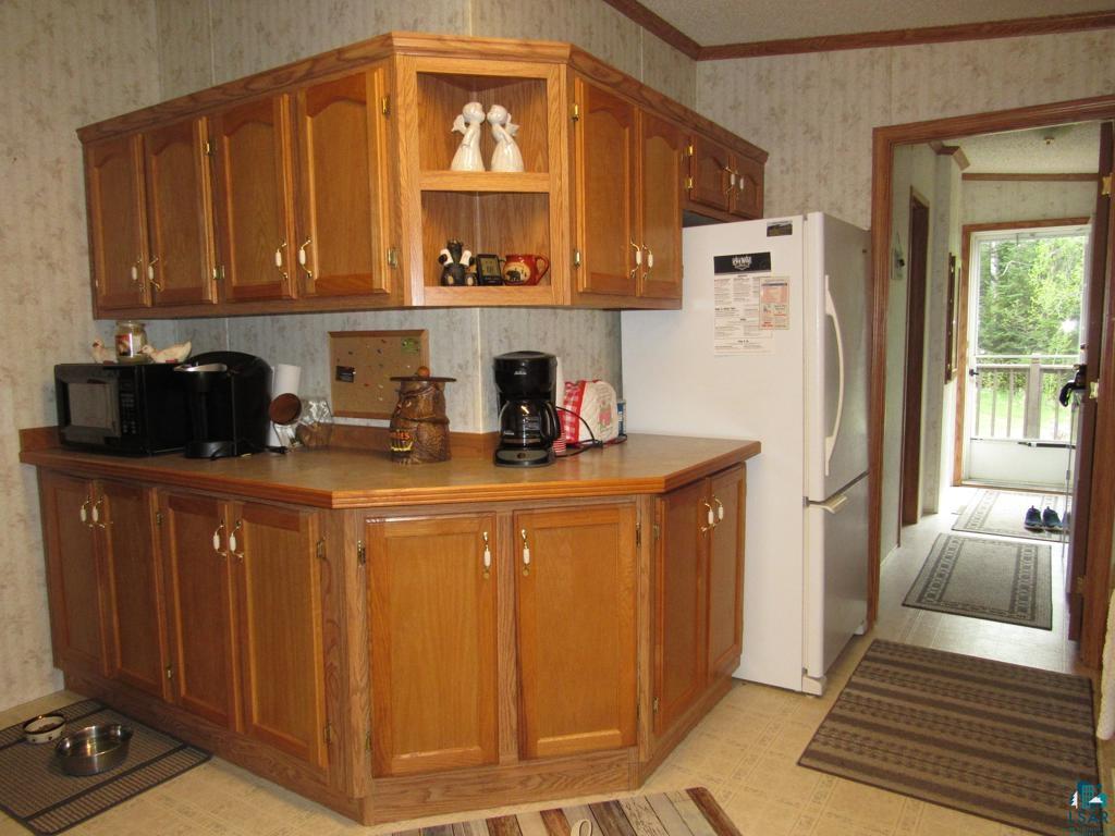 5243 East Neuman Road Superior, WI 54880 - Photo 9 of 35 Kitchen with crown molding, white fridge, and light tile floors