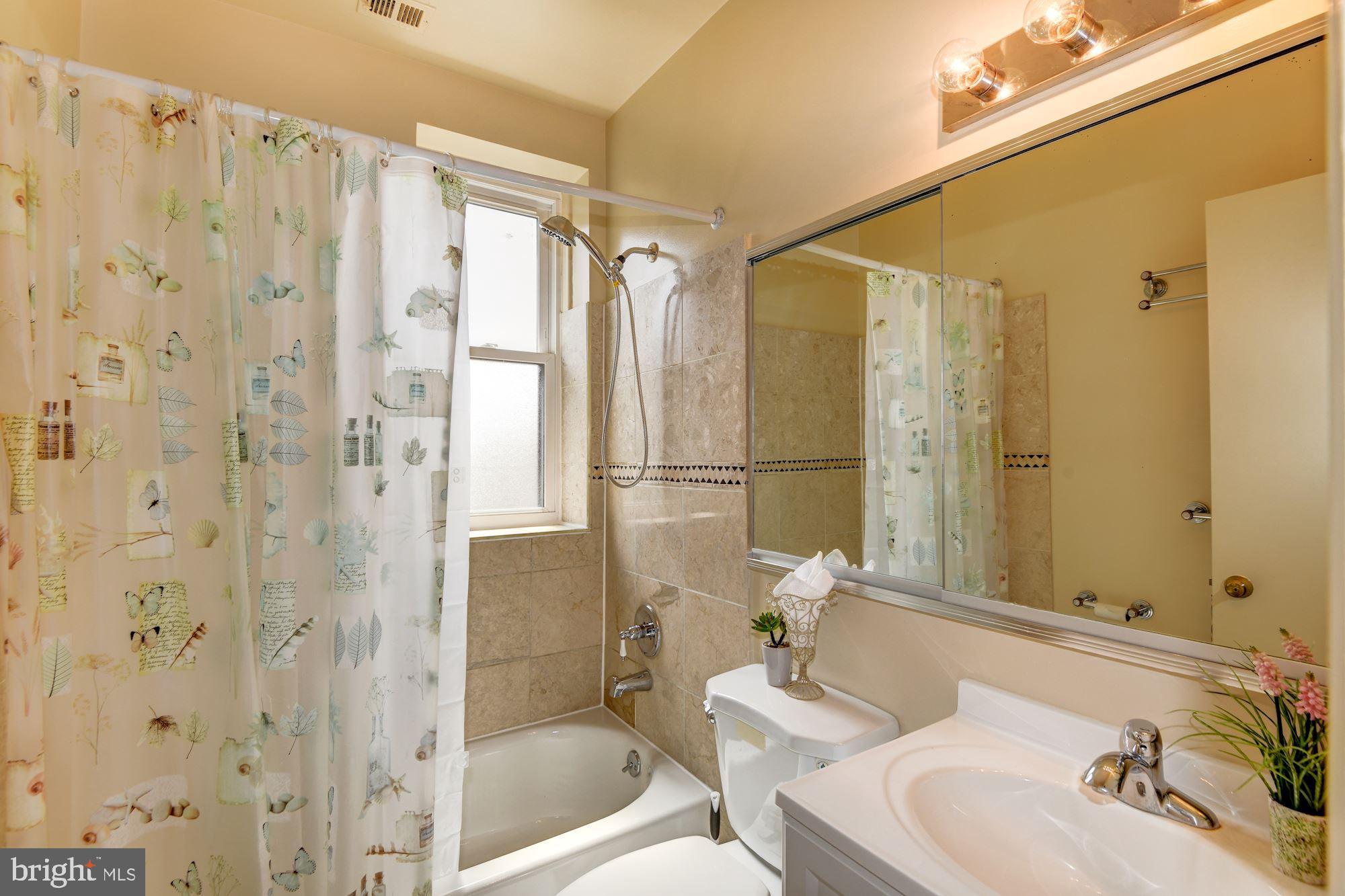 2001 16th Street Northwest, Unit 404 Washington, DC 20009 - Photo 16 of 35 Bright bathroom with window and tiles