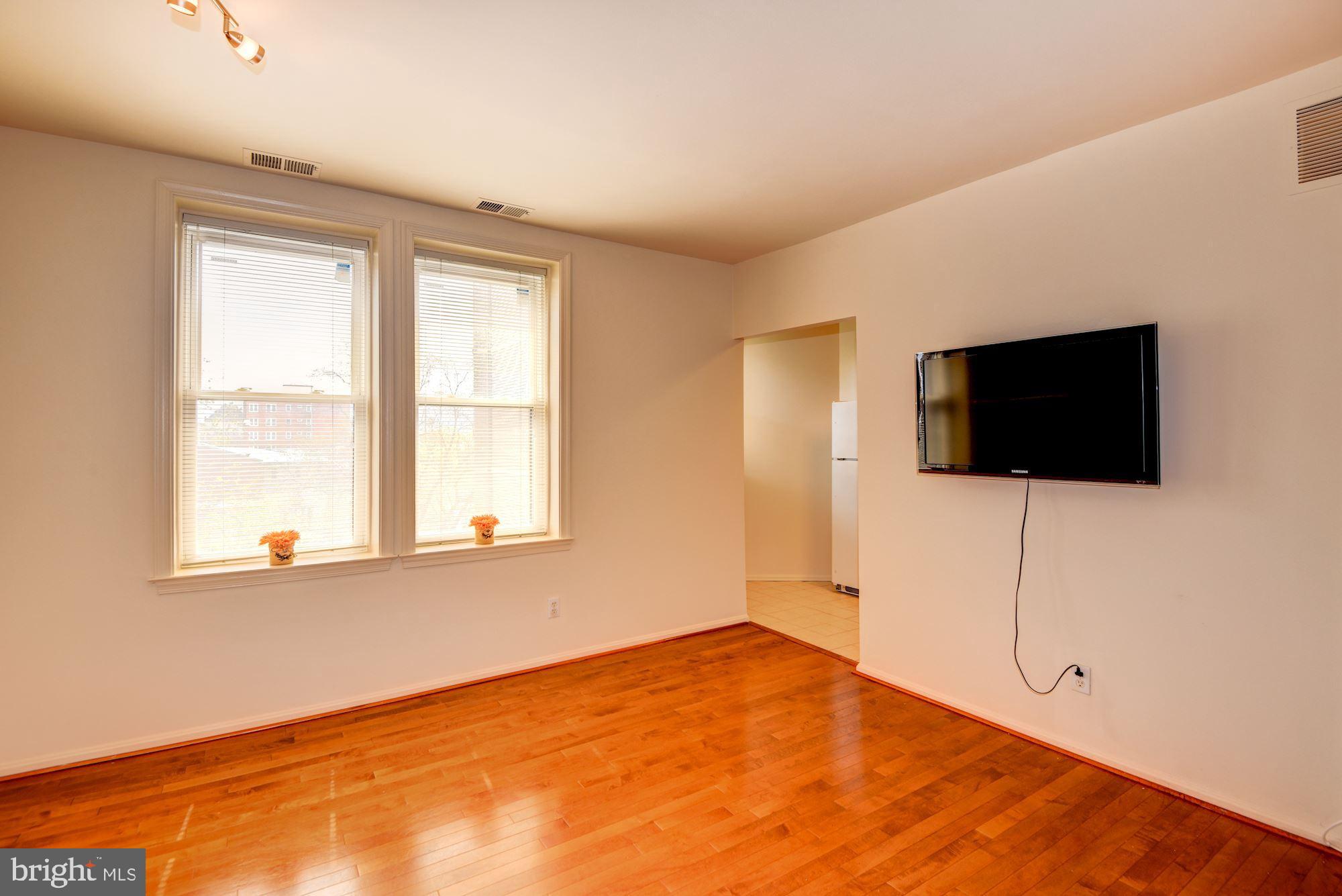 2001 16th Street Northwest, Unit 404 Washington, DC 20009 - Photo 7 of 35 Living room with flat screen TV that conveys