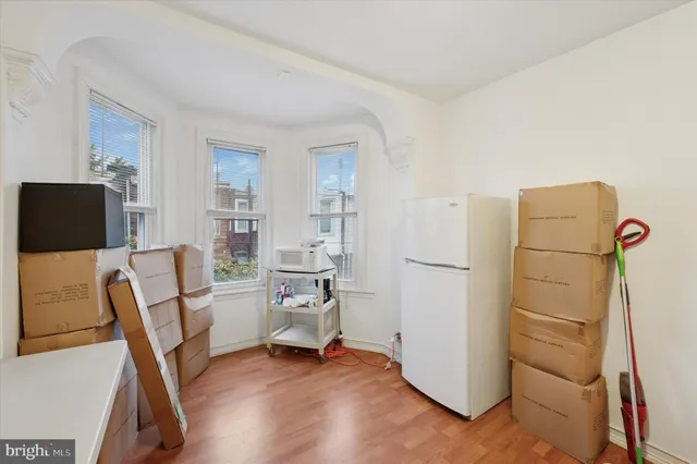 a view of a workspace with furniture and a refrigerator