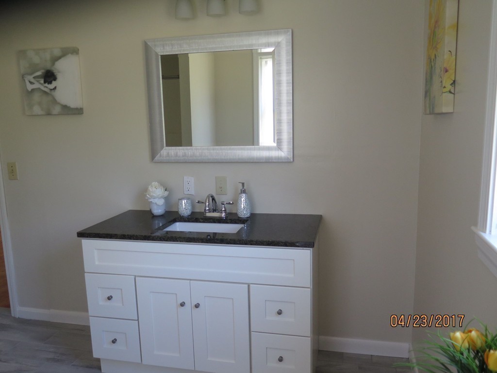 16 Mashapaug Road Sturbridge, MA 01566 - Photo 11 of 26 a bathroom with a granite countertop sink and a mirror