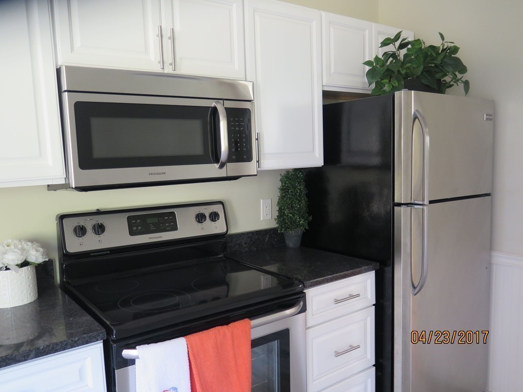 16 Mashapaug Road Sturbridge, MA 01566 - Photo 13 of 26 a kitchen with a refrigerator stove and microwave