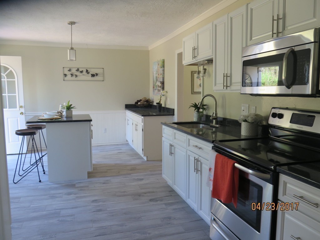16 Mashapaug Road Sturbridge, MA 01566 - Photo 15 of 26 a kitchen with granite countertop a stove and a sink
