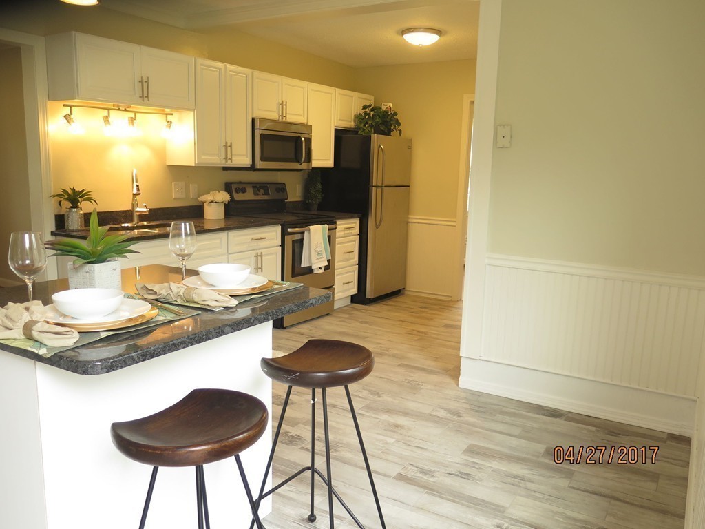 16 Mashapaug Road Sturbridge, MA 01566 - Photo 16 of 26 a kitchen with a table and chairs in it