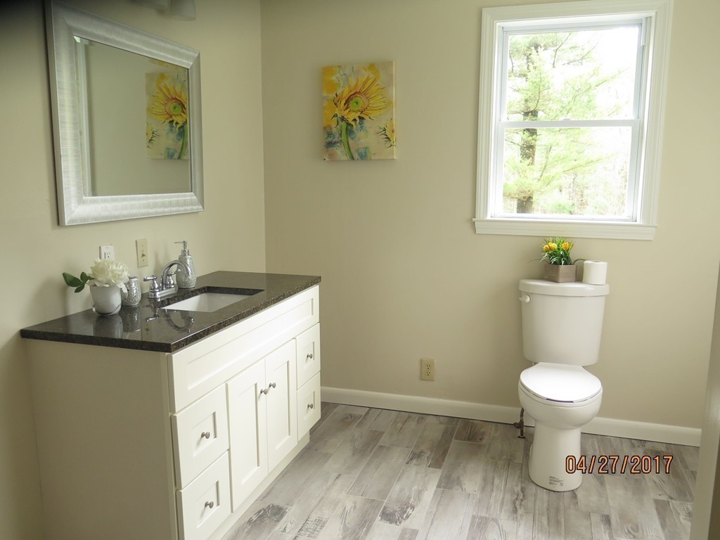 16 Mashapaug Road Sturbridge, MA 01566 - Photo 19 of 26 a bathroom with a granite countertop sink toilet and a mirror