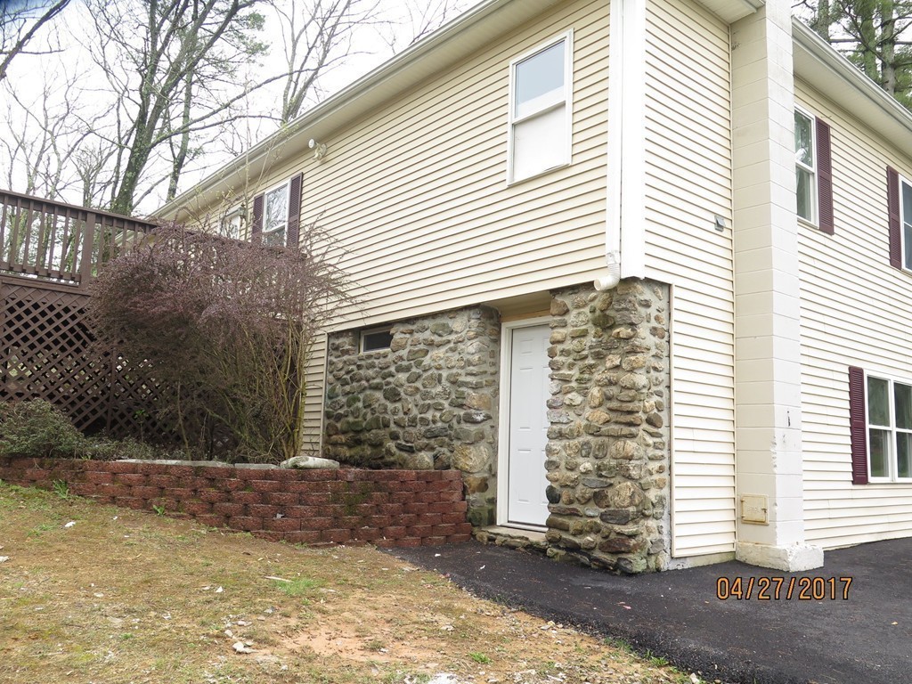 16 Mashapaug Road Sturbridge, MA 01566 - Photo 21 of 26 a front view of a house with a yard