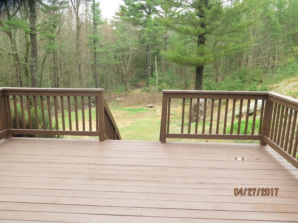 16 Mashapaug Road Sturbridge, MA 01566 - Photo 22 of 26 a view of a balcony with wooden floor and fence