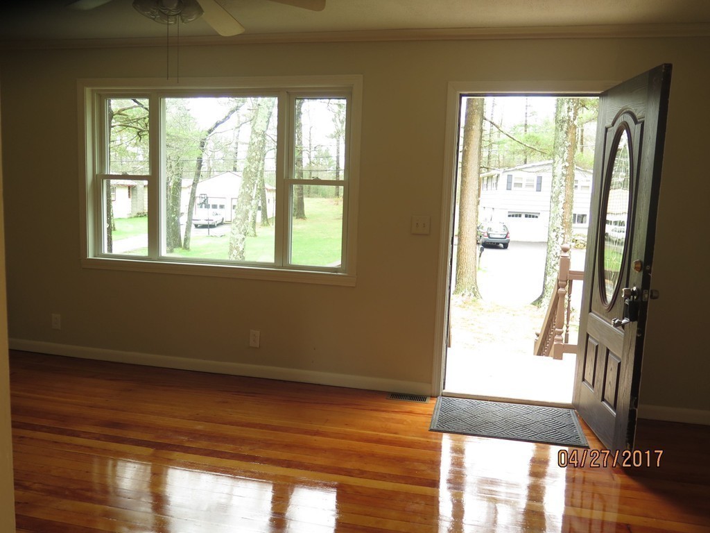 16 Mashapaug Road Sturbridge, MA 01566 - Photo 4 of 26 a view of an empty room with wooden floor and a window