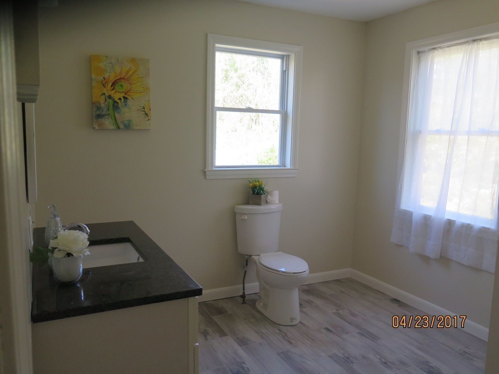 16 Mashapaug Road Sturbridge, MA 01566 - Photo 10 of 26 a bathroom with a toilet a sink a window and mirror
