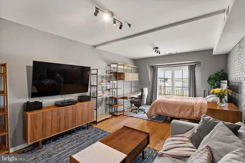 a living room with furniture and a flat screen tv