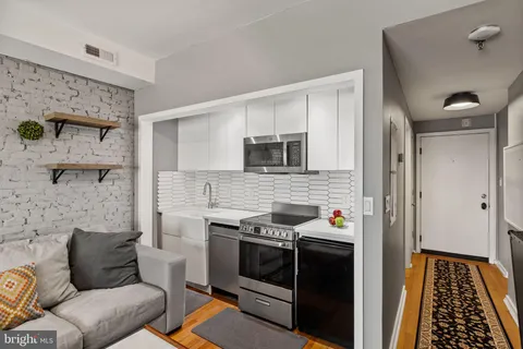 a hallway with a stove and a microwave oven