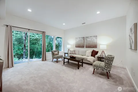 a living room with furniture and a floor to ceiling window