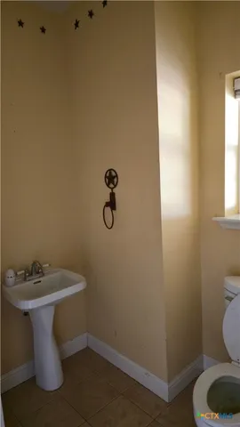 a white toilet sitting next to a bathroom sink