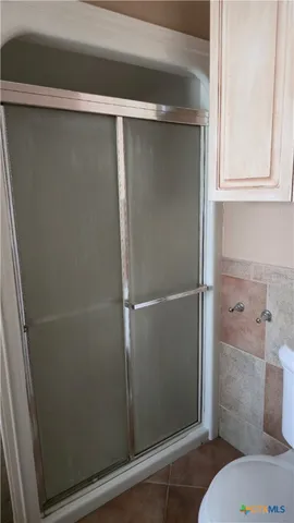 a bathroom with a glass shower door