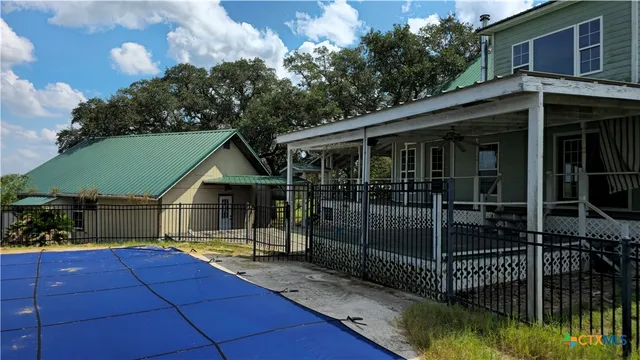 a view of a house with backyard and porch