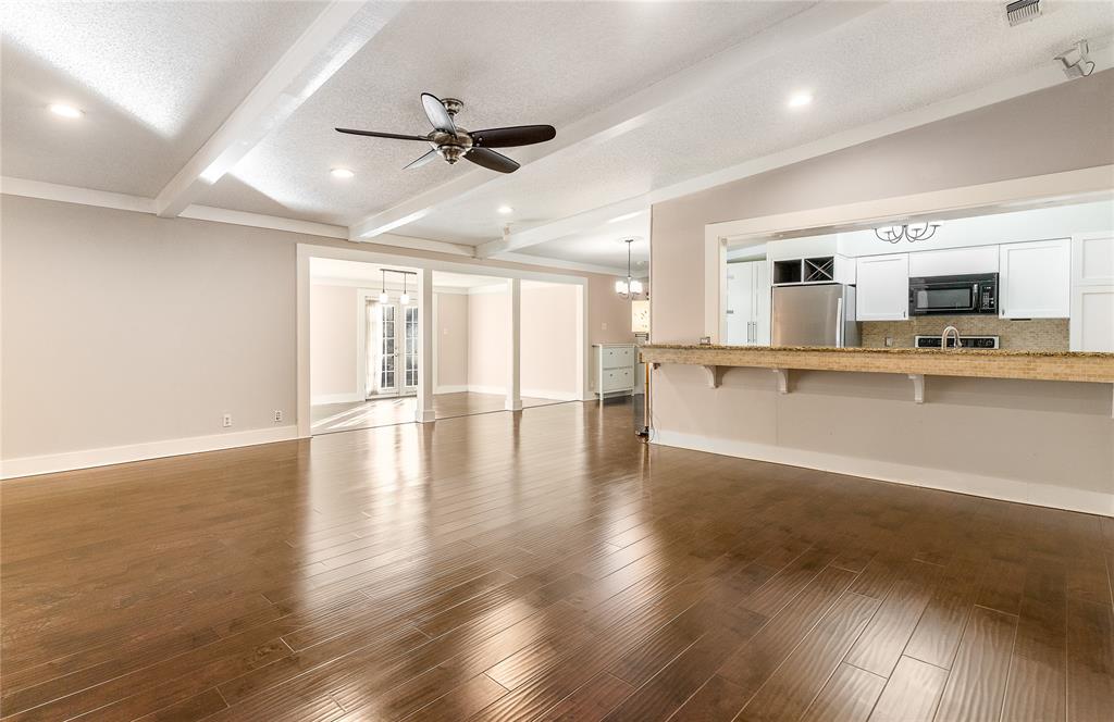 203 Walnut Way Euless, TX 76039 - Photo 1 of 36 an empty room with wooden floor and windows