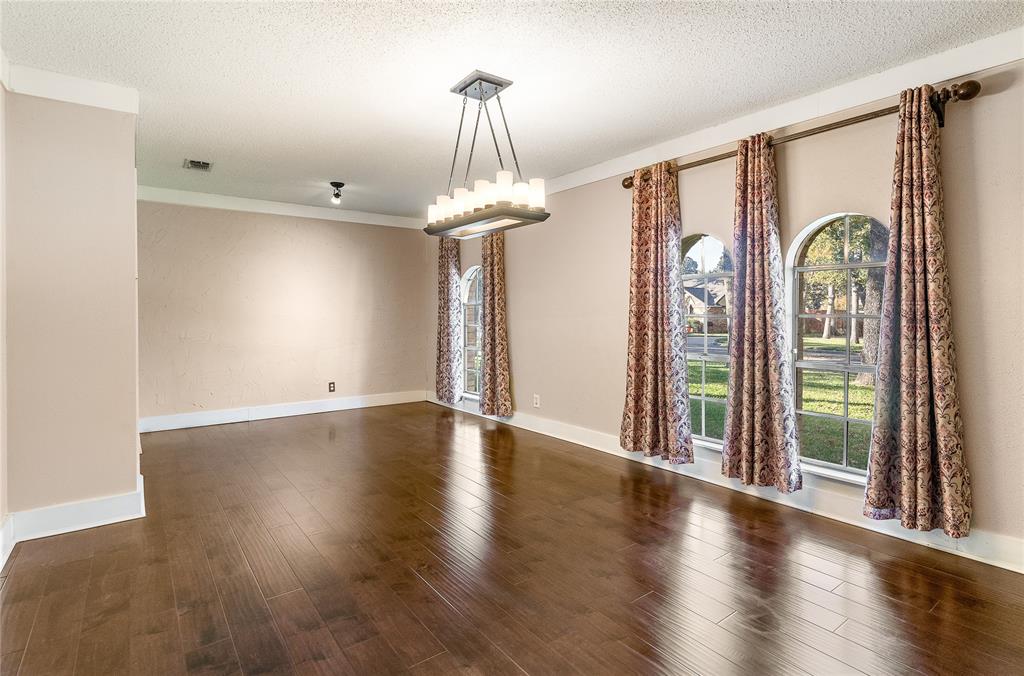 203 Walnut Way Euless, TX 76039 - Photo 12 of 36 a view of a room with wooden floor fan and windows