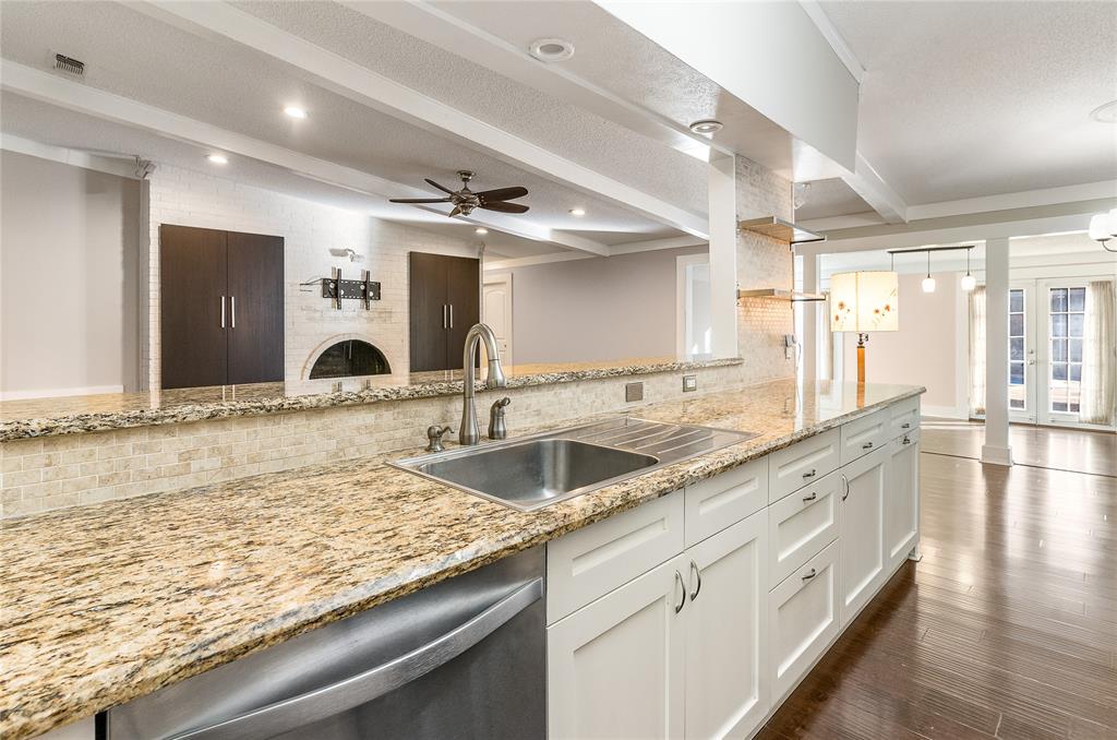 203 Walnut Way Euless, TX 76039 - Photo 14 of 36 a large kitchen with granite countertop a sink and a wooden floor