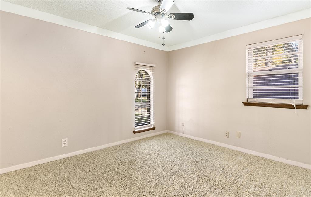 203 Walnut Way Euless, TX 76039 - Photo 18 of 36 an empty room with windows and fan