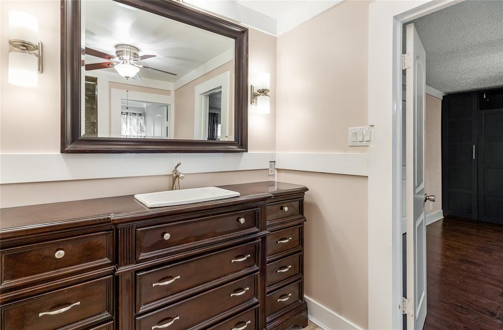 203 Walnut Way Euless, TX 76039 - Photo 24 of 36 a bathroom with a sink a vanity and a mirror