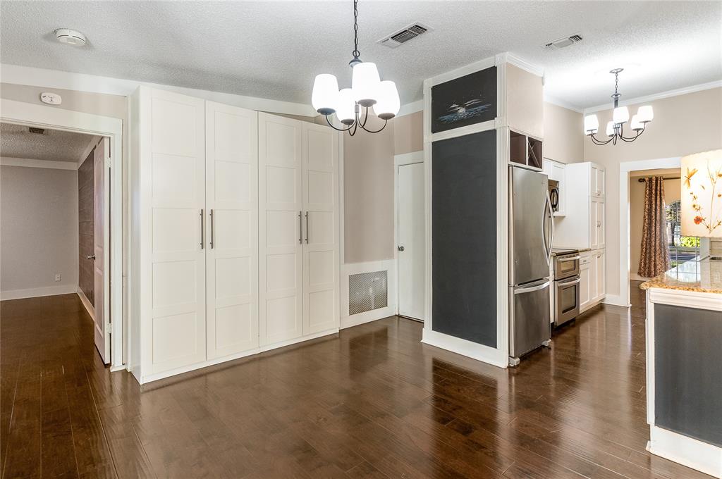 203 Walnut Way Euless, TX 76039 - Photo 25 of 36 a view of a livingroom with wooden floor and a kitchen space