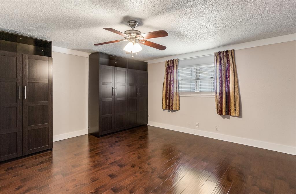 203 Walnut Way Euless, TX 76039 - Photo 26 of 36 a view of an empty room with wooden floor and a window