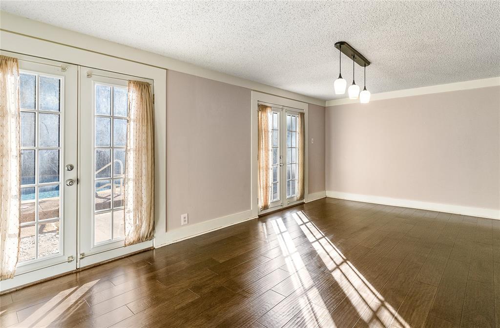 203 Walnut Way Euless, TX 76039 - Photo 10 of 36 a view of an empty room with wooden floor and a window