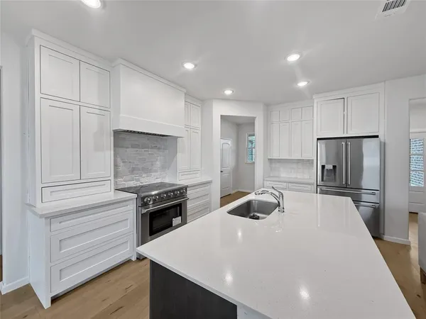a kitchen with a sink and a stove top oven