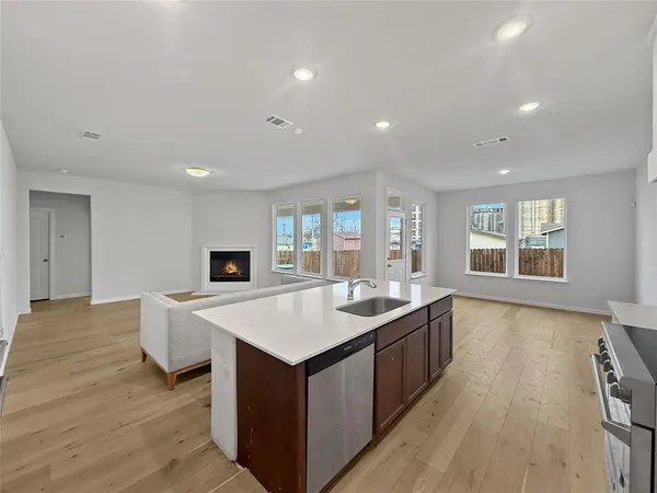 a living room with furniture and a refrigerator