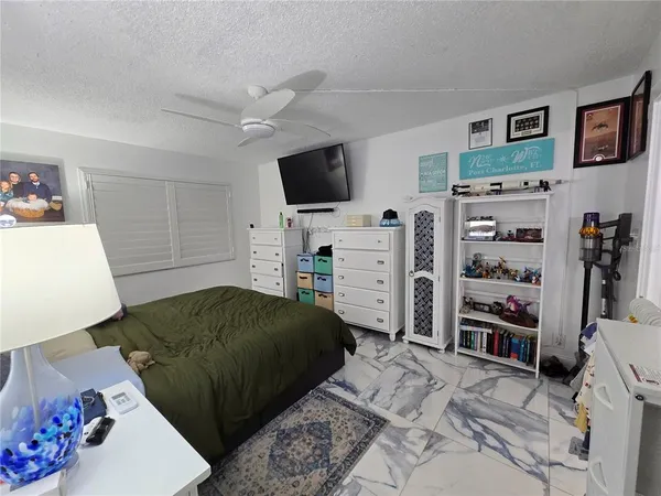 a bedroom with a bed and flat screen tv