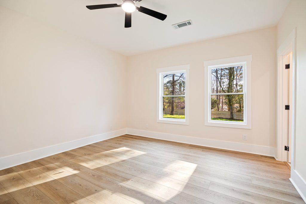 1755 Snapfinger Road Decatur, GA 30032 - Photo 28 of 52 a view of an empty room with a window and wooden floor
