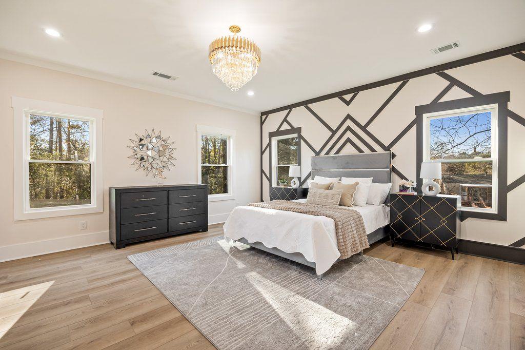 1755 Snapfinger Road Decatur, GA 30032 - Photo 33 of 52 a spacious bedroom with a bed dresser and wooden floor