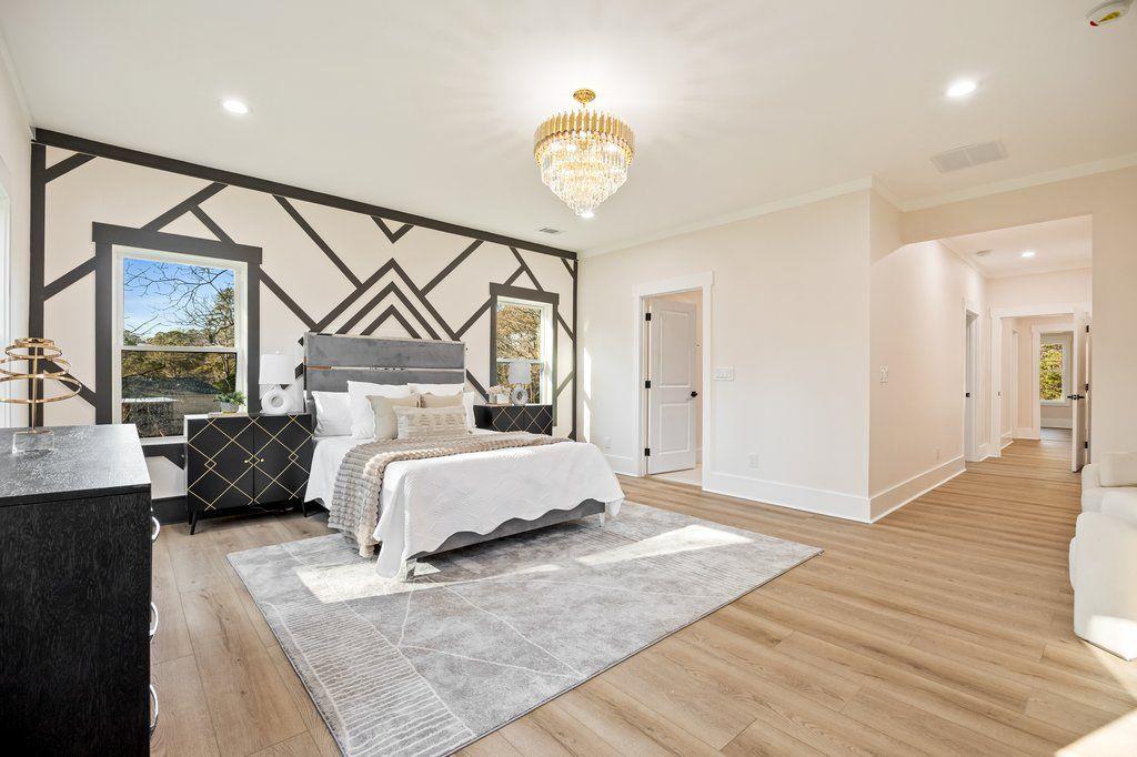 1755 Snapfinger Road Decatur, GA 30032 - Photo 34 of 52 a bedroom with a bed and a chandelier