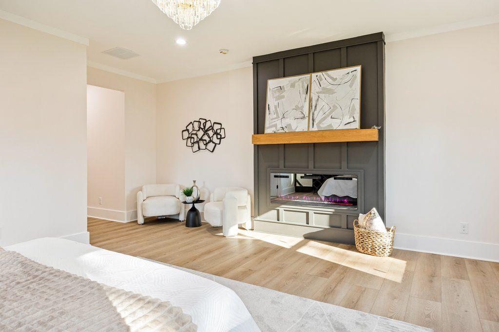 1755 Snapfinger Road Decatur, GA 30032 - Photo 35 of 52 a bedroom with a bed and a chandelier