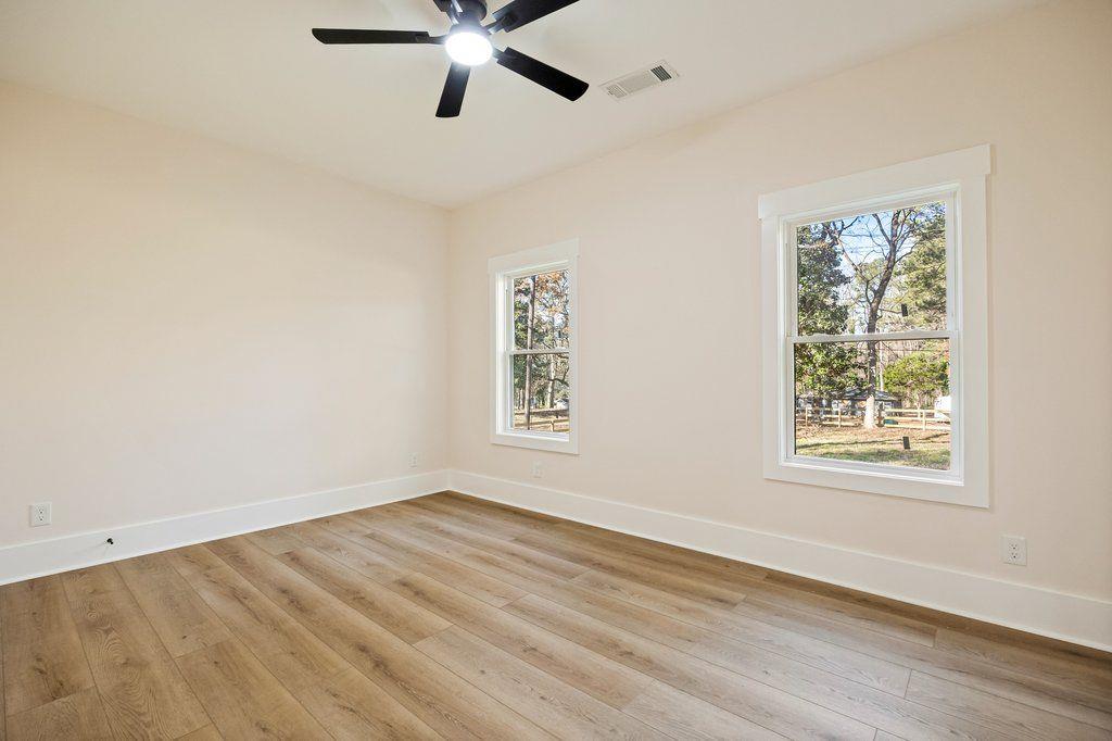 1755 Snapfinger Road Decatur, GA 30032 - Photo 39 of 52 a view of an empty room with wooden floor and a window