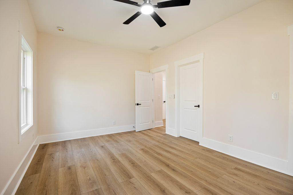 1755 Snapfinger Road Decatur, GA 30032 - Photo 40 of 52 an empty room with wooden floor ceiling fan and windows