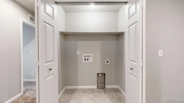 a view of a livingroom with wooden floor and a hallway