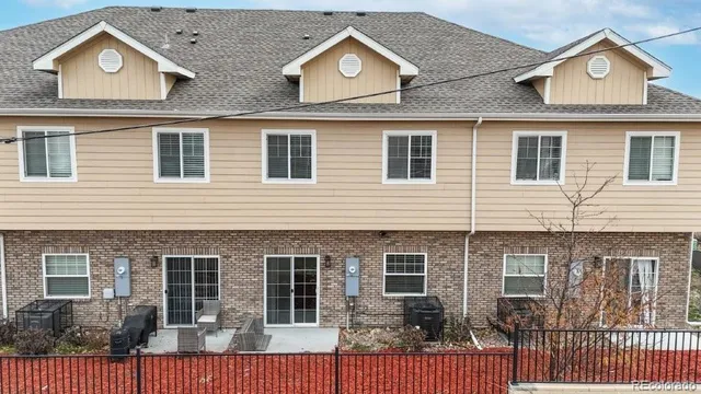 a view of a brick house with large windows