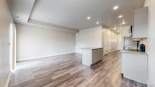 a kitchen with a refrigerator and a stove top oven