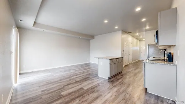 a kitchen with a refrigerator and a stove top oven