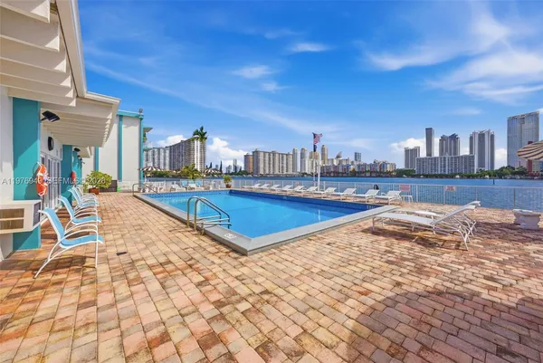 a view of a swimming pool with outdoor seating