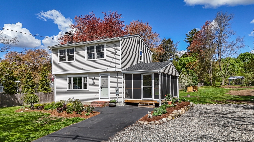 196 Center Street Groveland, MA 01834 - Photo 25 of 32 a front view of a house with a garden and outdoor seating
