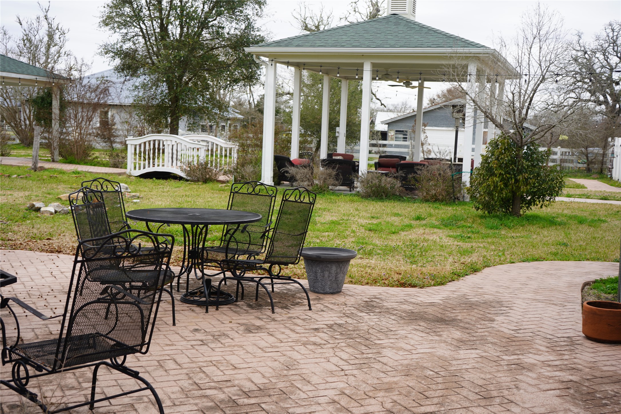 9500 Mayfield Avenue, Unit C Shiro, TX 77873 - Photo 11 of 12 a view of a patio with a table chairs and a yard
