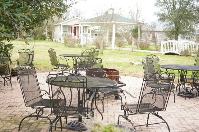a view of an outdoor dining space with furniture and garden
