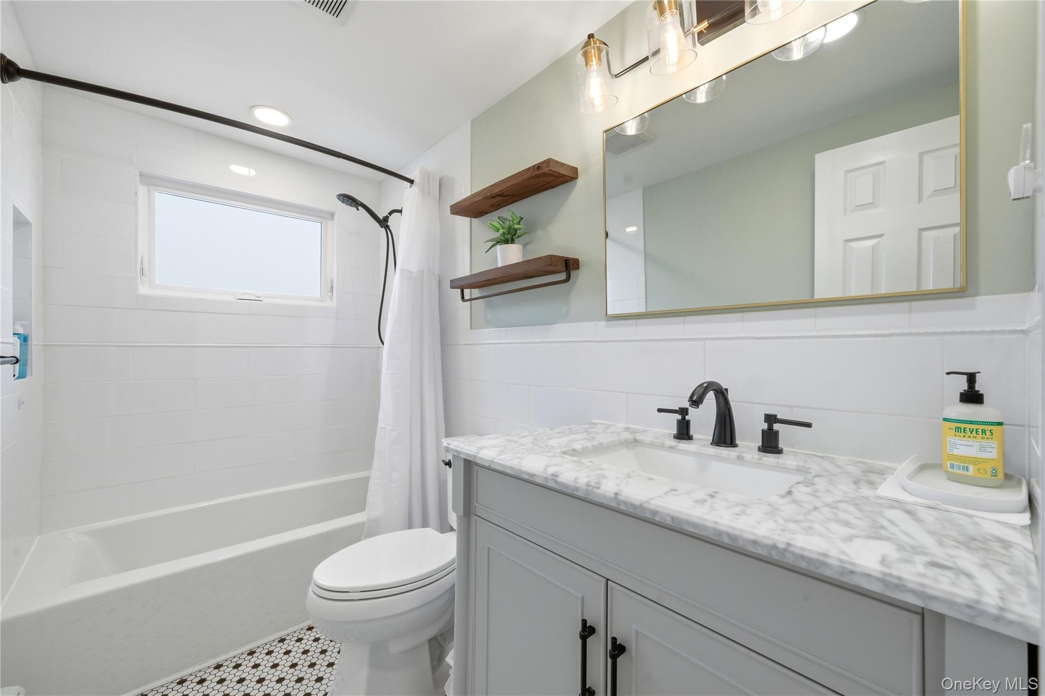 214 Ralph Avenue Babylon, NY 11702 - Photo 12 of 33 a bathroom with a sink a toilet and a bathtub