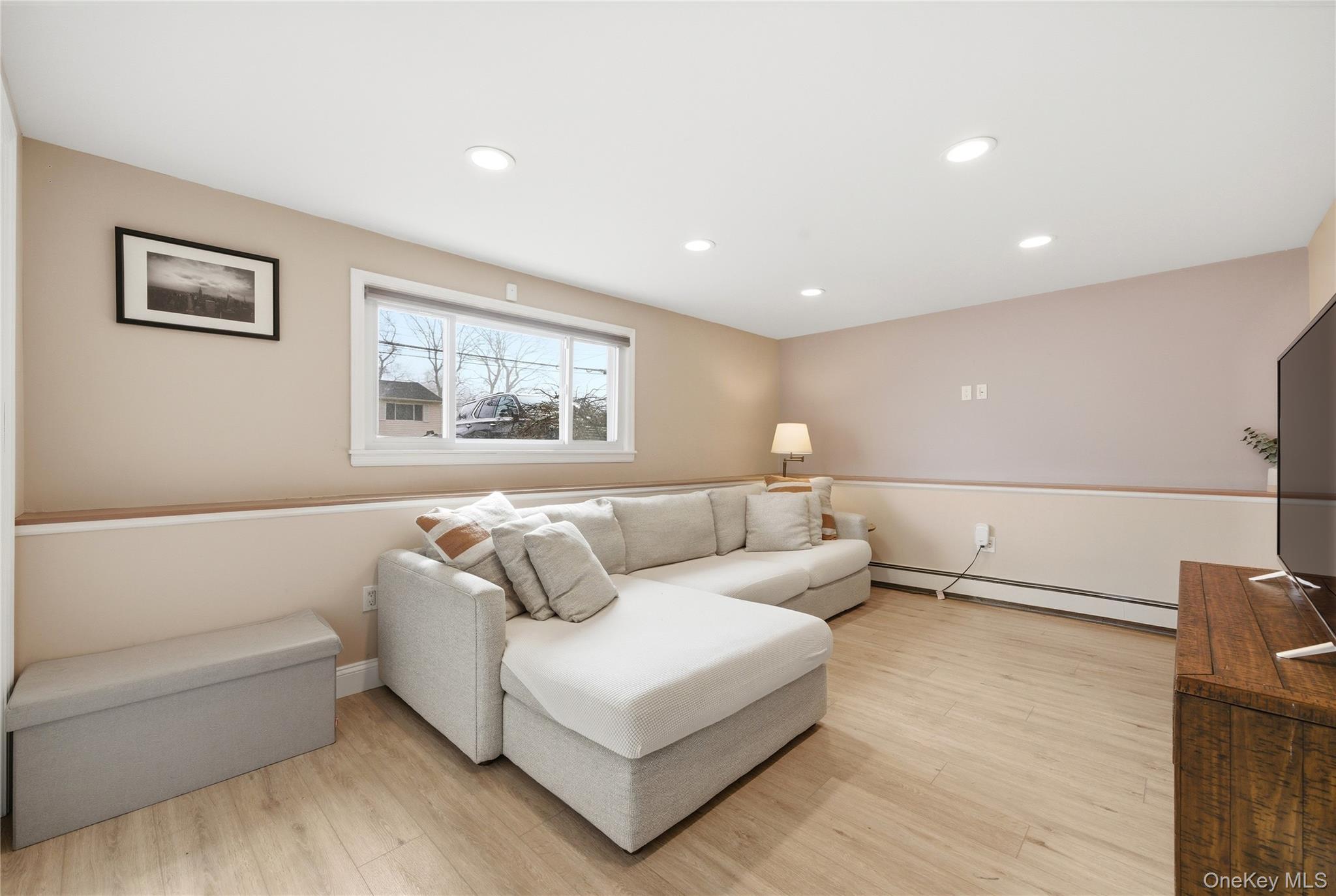 214 Ralph Avenue Babylon, NY 11702 - Photo 15 of 33 a living room with furniture and a large window
