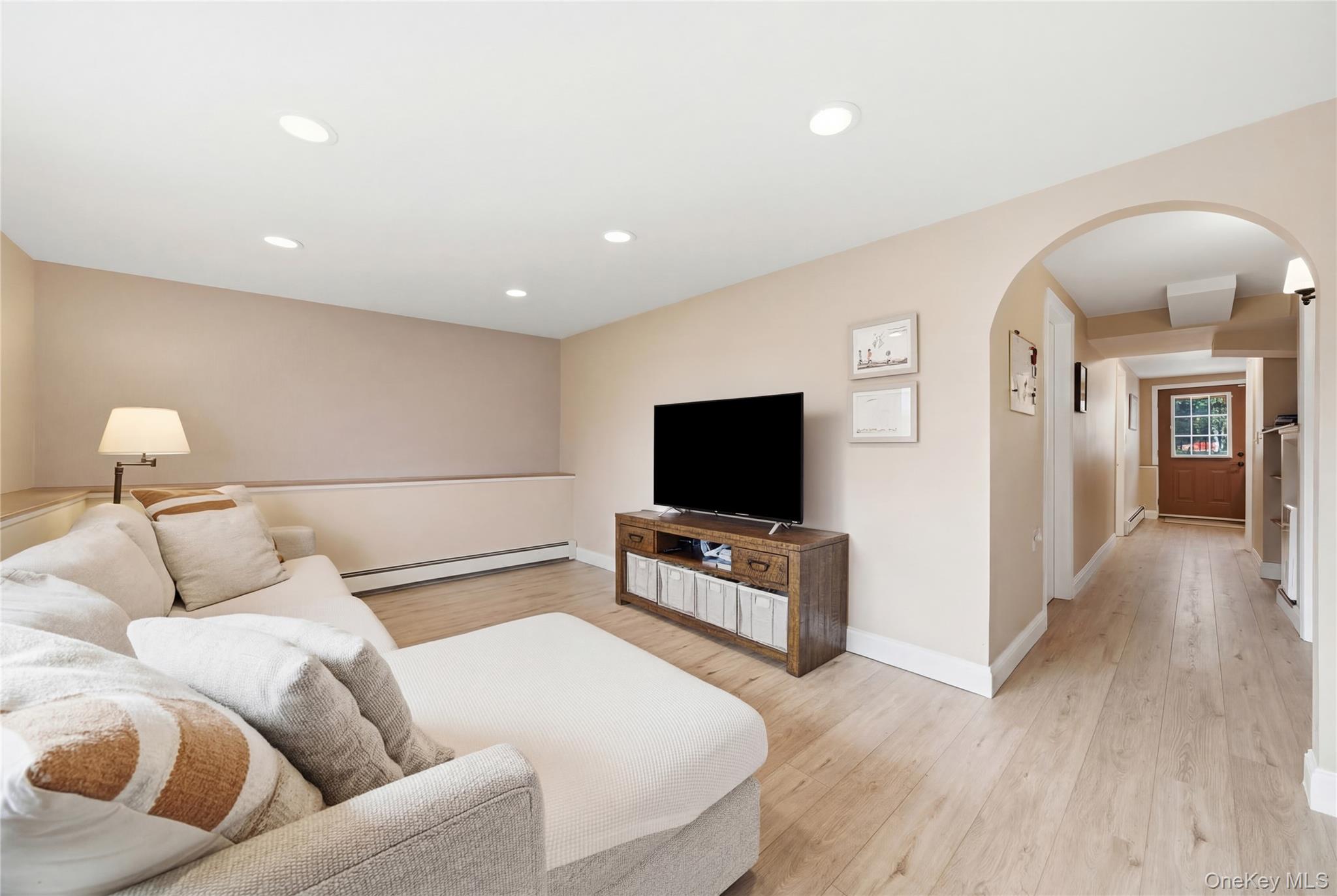 214 Ralph Avenue Babylon, NY 11702 - Photo 16 of 33 a living room with furniture and a flat screen tv