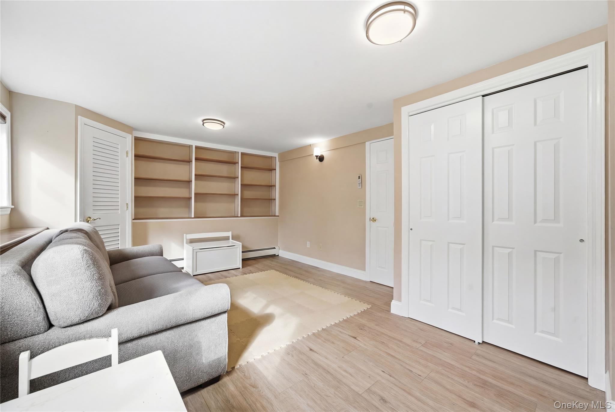 214 Ralph Avenue Babylon, NY 11702 - Photo 18 of 33 a living room with furniture and a window