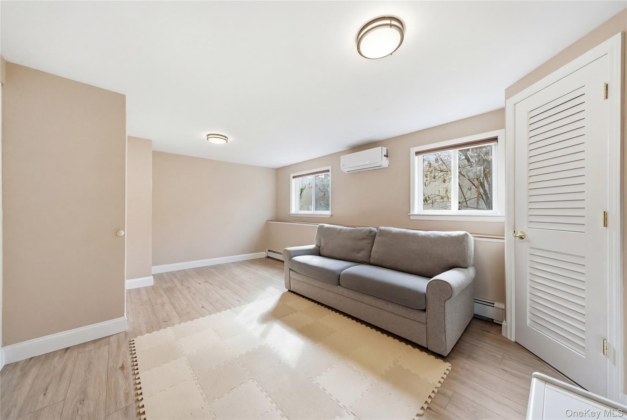 214 Ralph Avenue Babylon, NY 11702 - Photo 19 of 33 a living room with furniture and a window