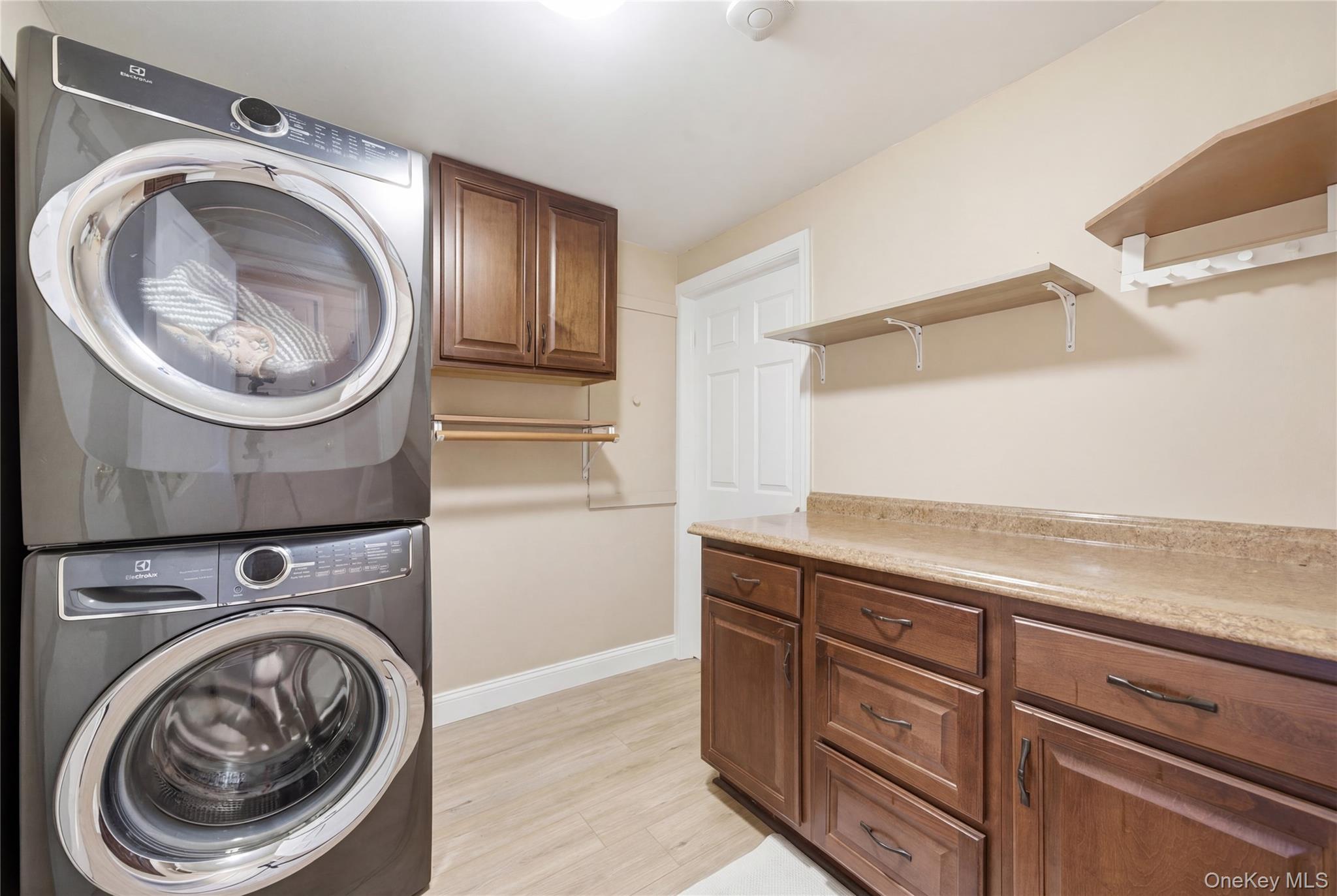 214 Ralph Avenue Babylon, NY 11702 - Photo 20 of 33 a view of a storage and utility room with washer and dryer